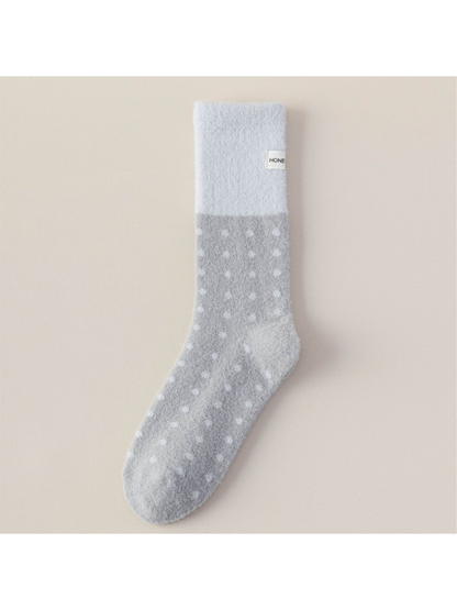 Gray fuzzy crew sock with pale blue cuff and white polka dots