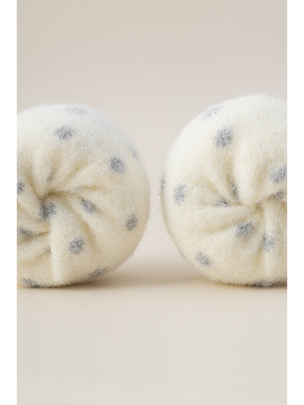 Macro view of the ivory fuzzy texture and gray polka-dot pattern