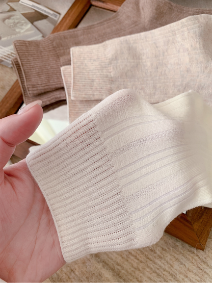 Close-up of the ribbed cuff opening and knit construction