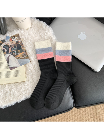 Black ribbed crew socks with blue and pink striped cuffs