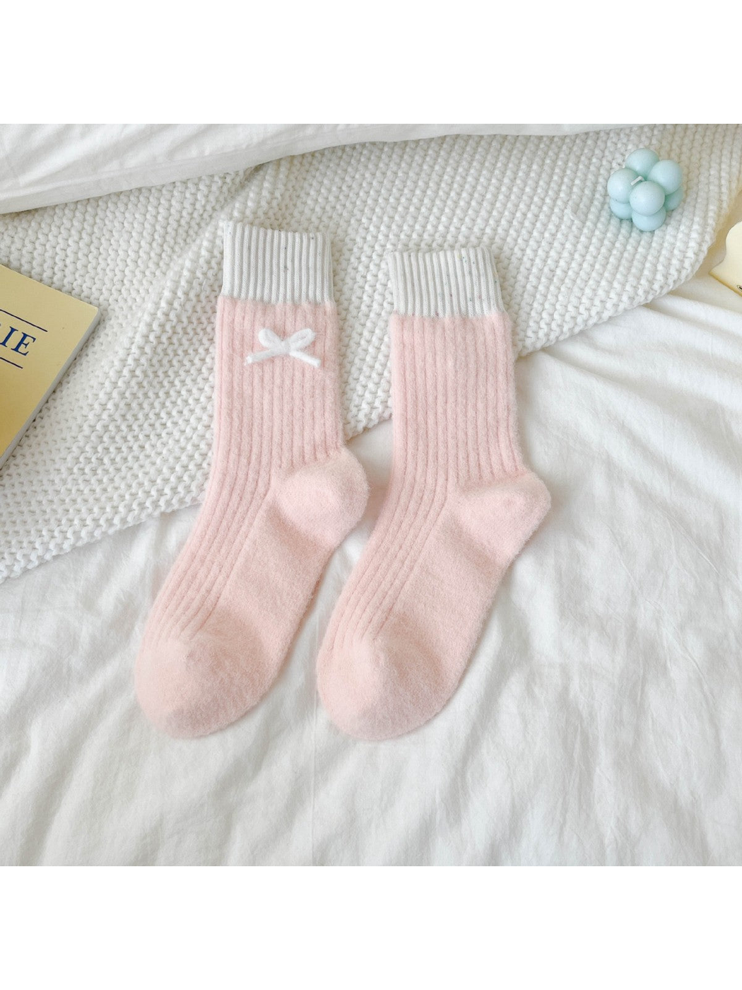 Light pink fuzzy ribbed crew socks with contrasting cuffs and white bow