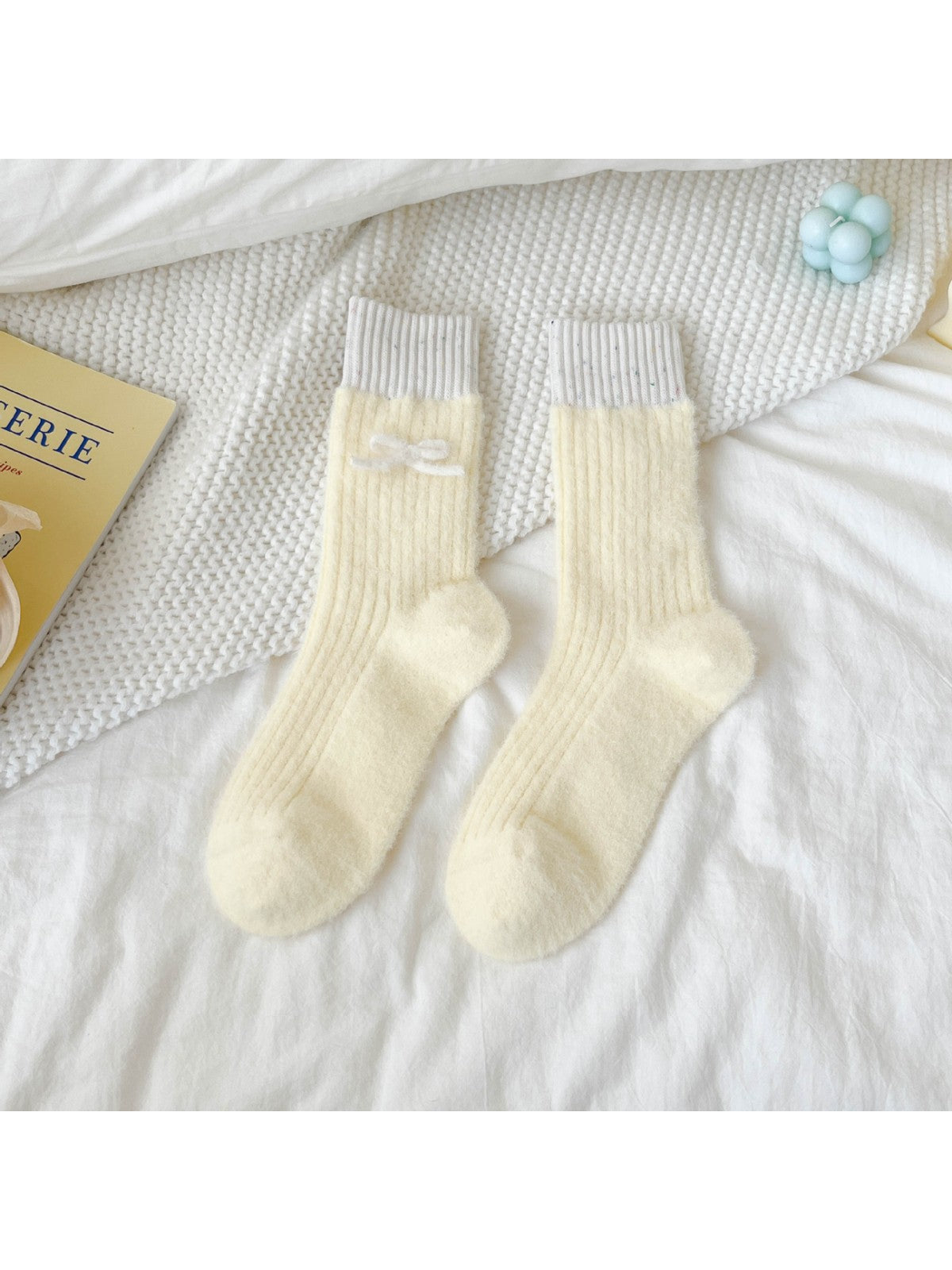 Pale yellow fuzzy ribbed crew socks with contrasting cuffs and white bow