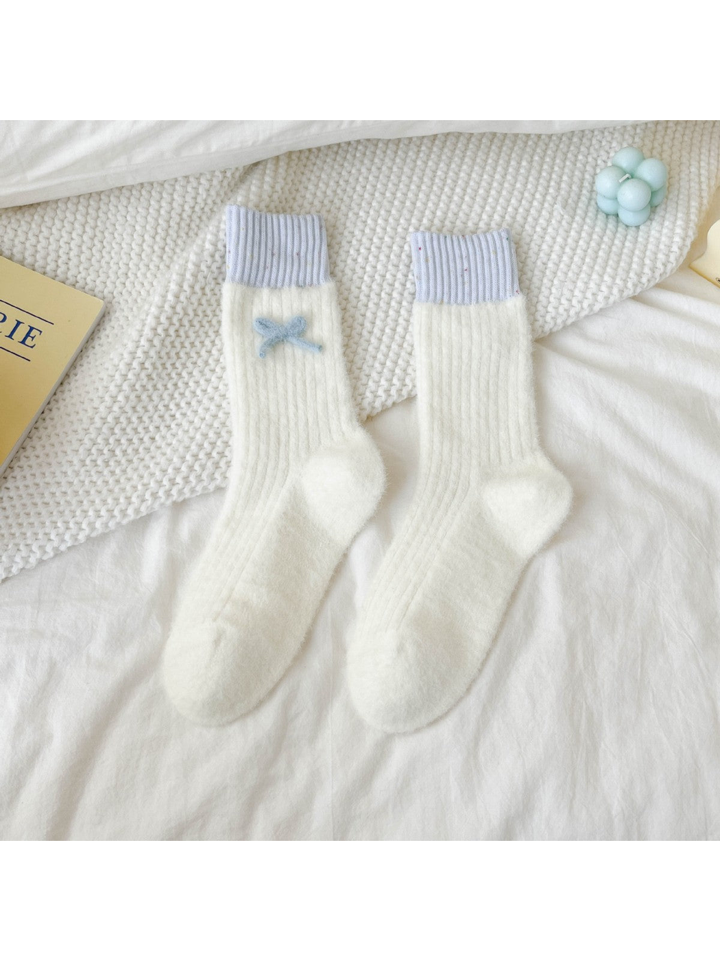 Ivory fuzzy ribbed crew socks with lavender cuffs and blue bow