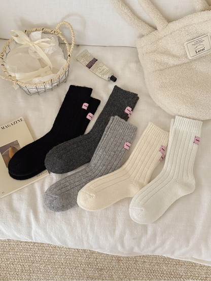 Five colors of ribbed crew socks arranged together in full-length views