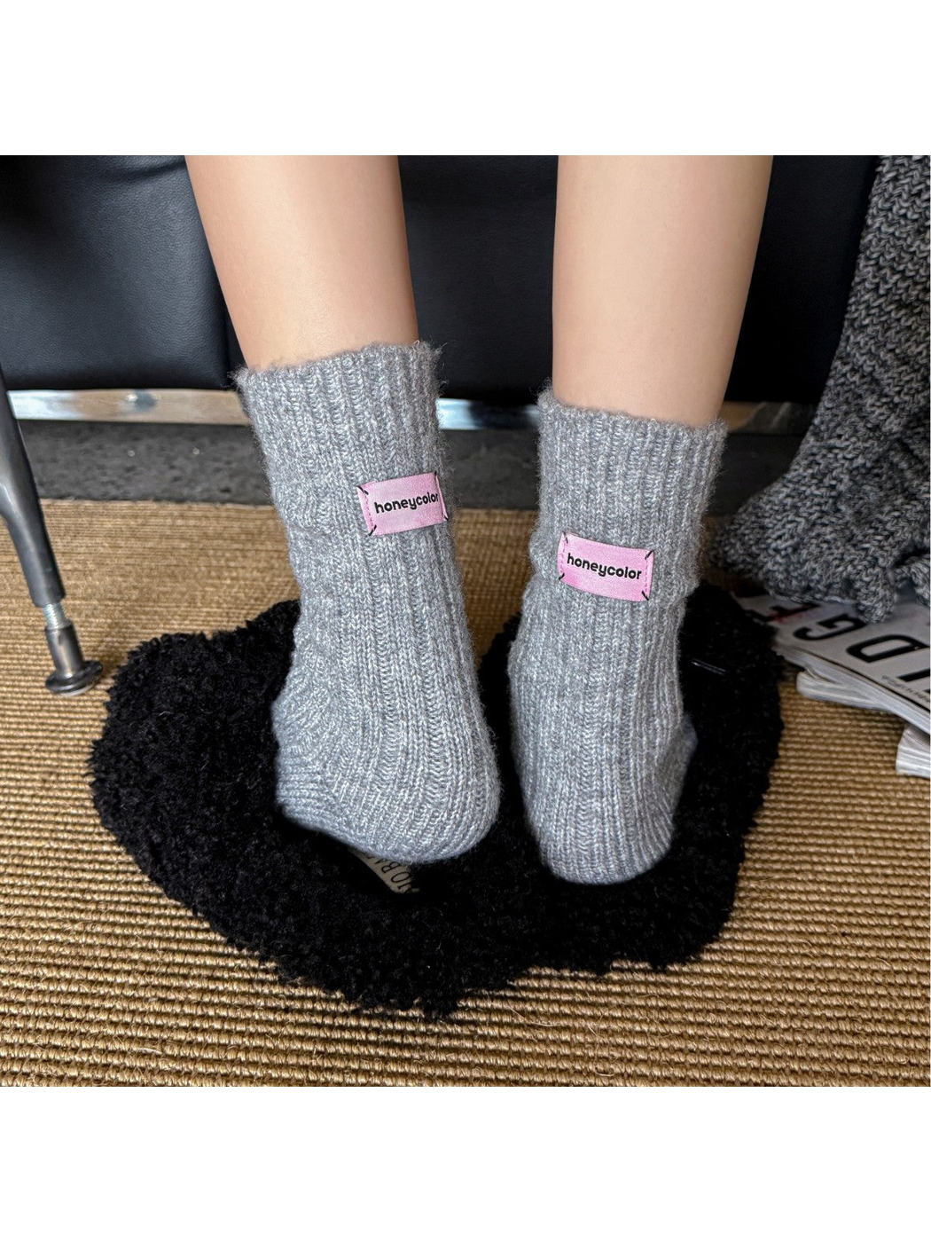 Light gray ribbed crew socks worn with the pink cuff patches facing forward
