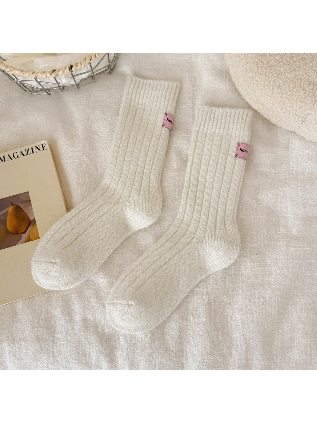 White ribbed crew socks with pink cuff patches, full pair view
