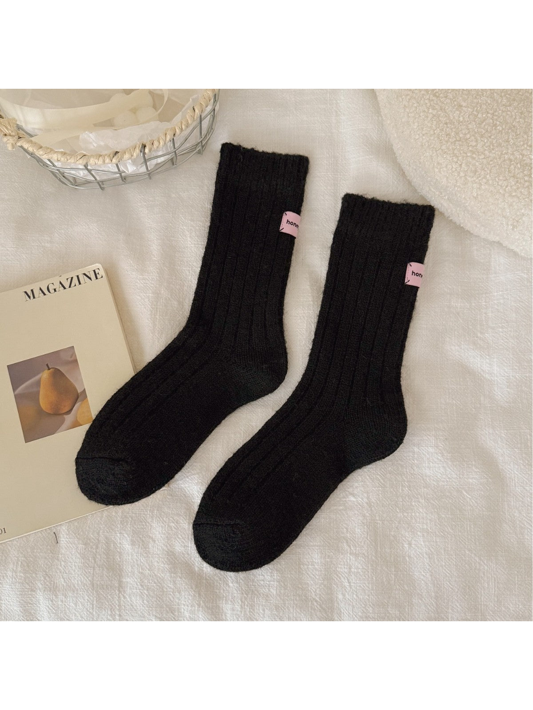Black ribbed crew socks with pink cuff patches, full pair view