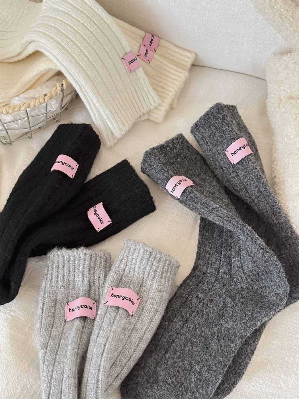Close-up of the ribbed knit texture and pink cuff patches across multiple sock colors