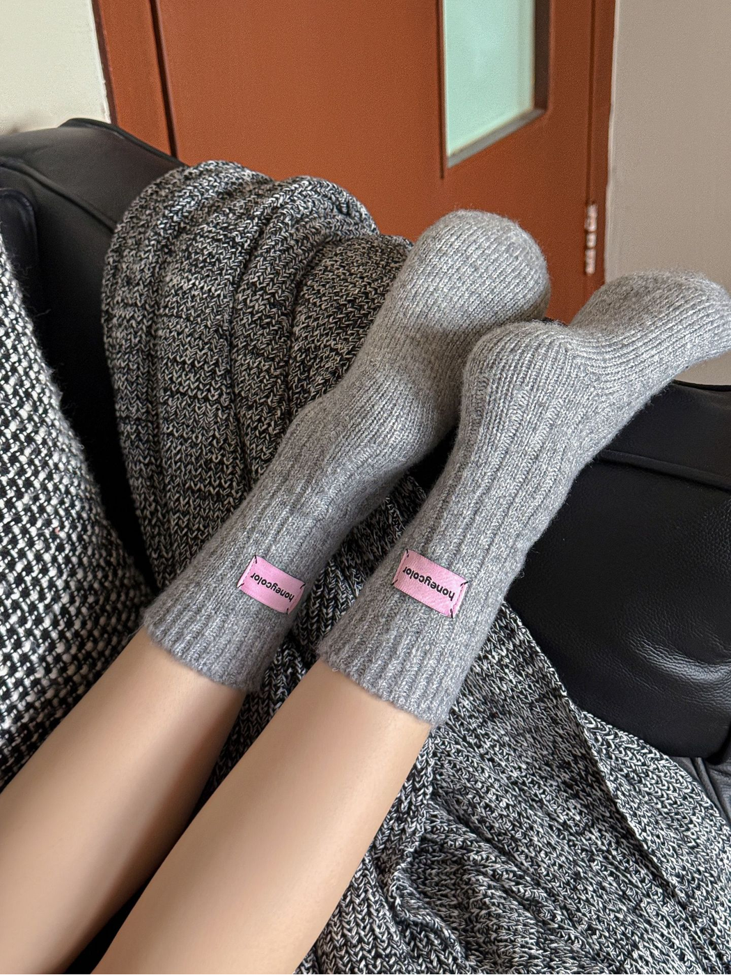 Light gray ribbed crew socks worn with the soles and rounded toes visible