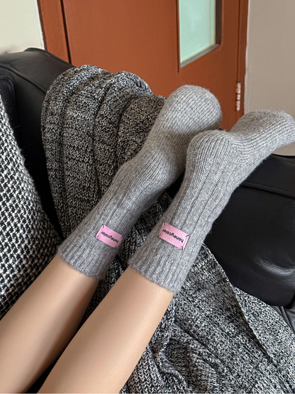 Light gray ribbed crew socks worn with the soles and rounded toes visible