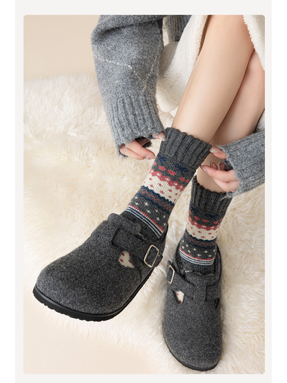 Dark gray patterned crew socks styled with gray buckle shoes
