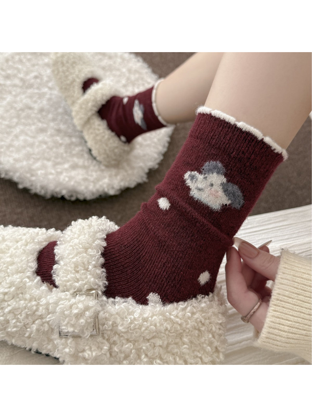 Burgundy dog motif crew socks worn with ivory textured slippers