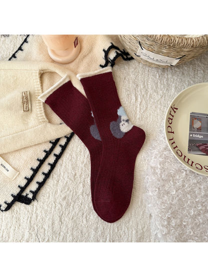 Burgundy crew socks with fuzzy dog motif at the heel