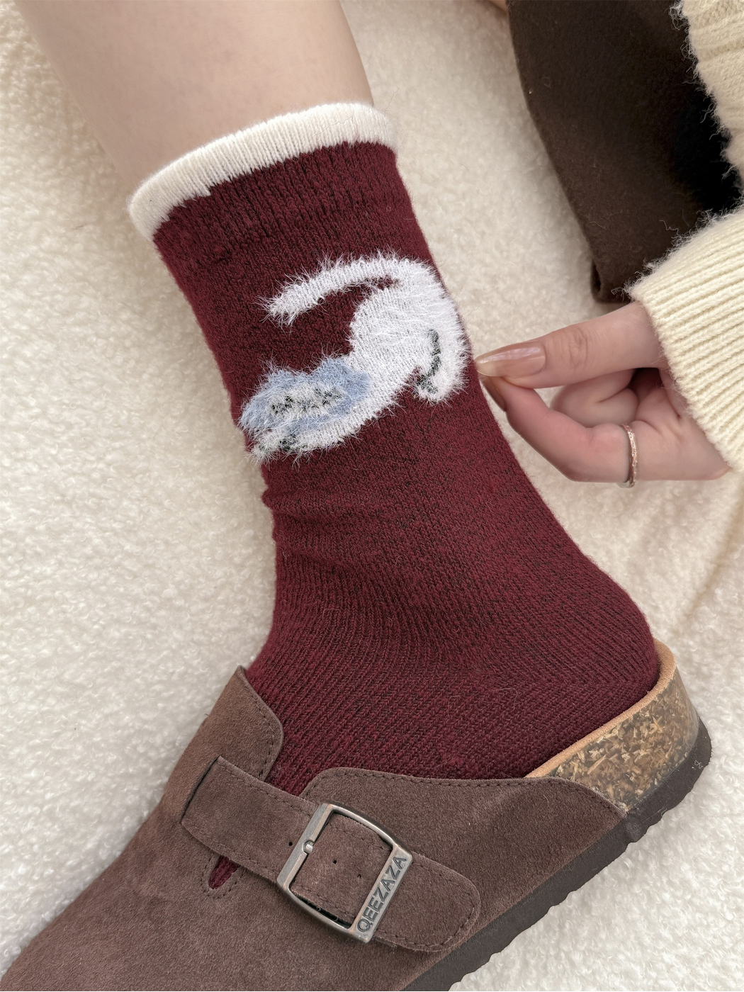 Close-up of the fuzzy curled animal motif and ivory cuff trim