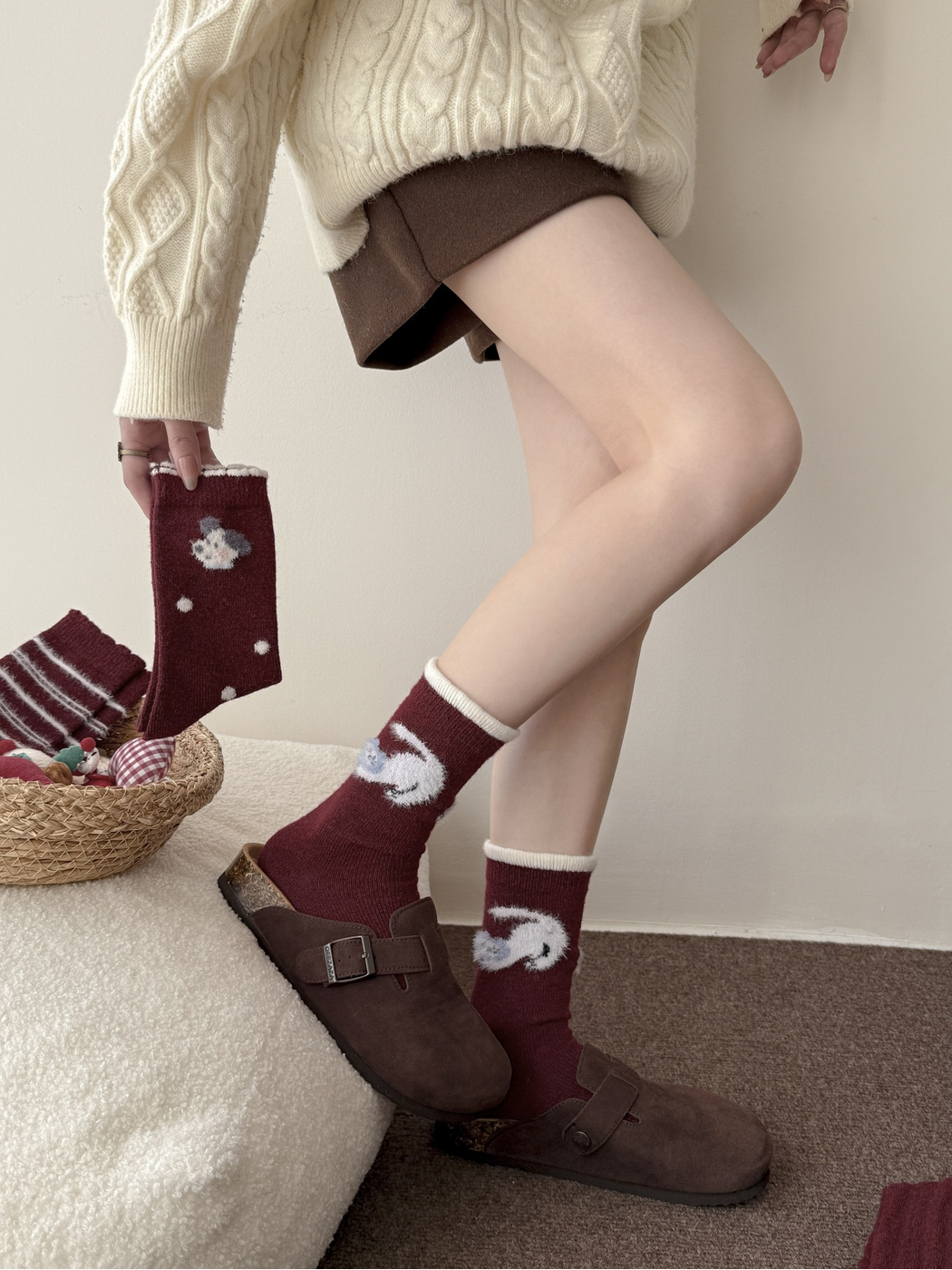 Burgundy animal motif crew socks worn with brown clogs