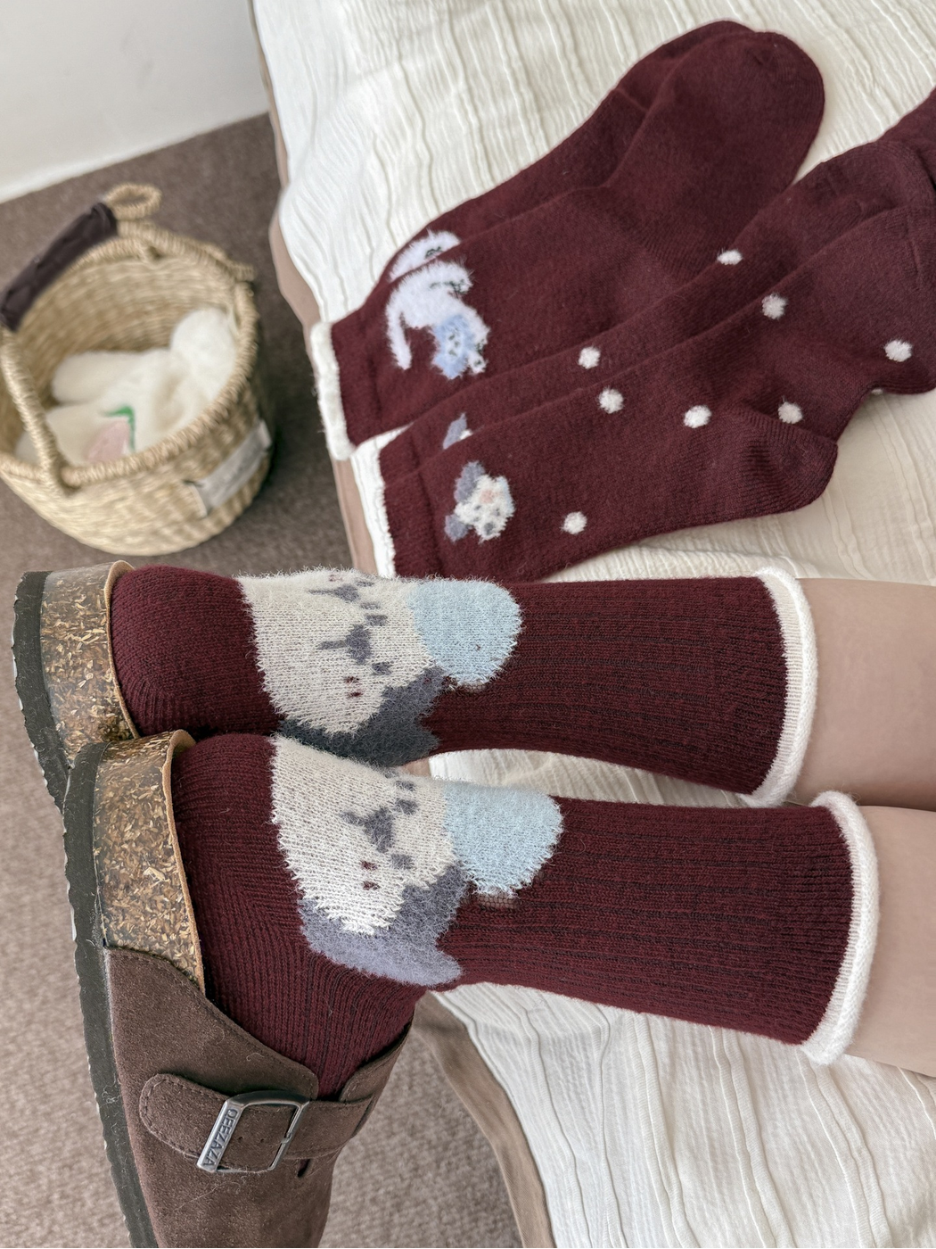 Burgundy heel motif crew socks worn with brown clogs beside coordinating designs
