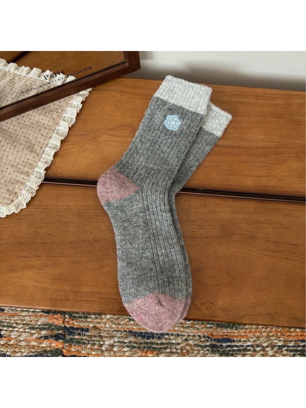 Gray ribbed crew socks with light cuffs, pink trim and snowflake embroidery