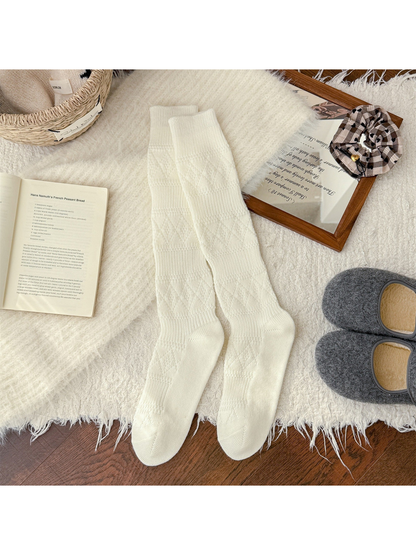Ivory knee-high textured socks laid flat