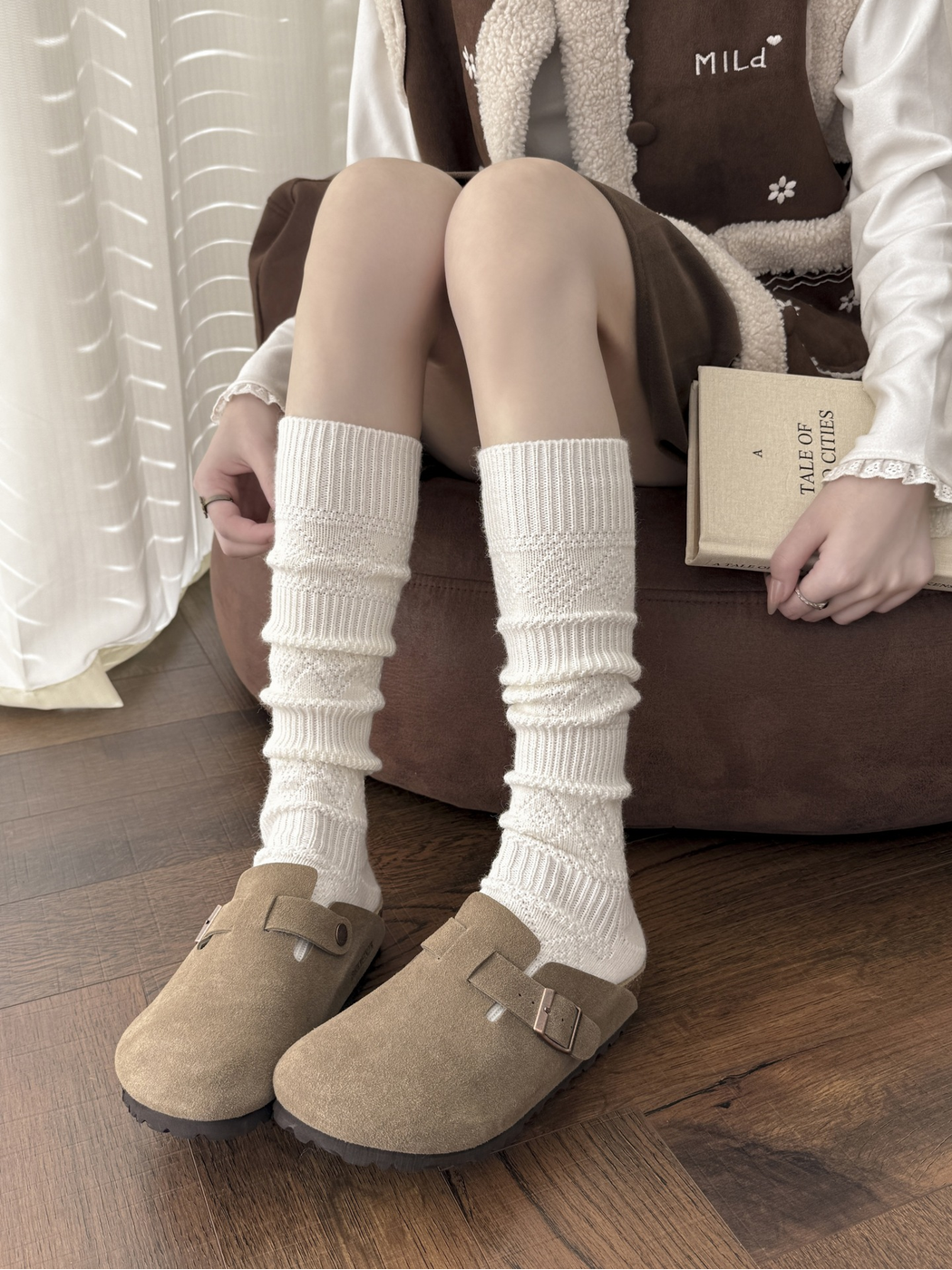 Ivory knee-high textured socks worn with beige clogs