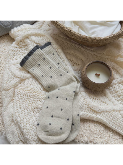 Ivory polka-dot crew socks with a gray ruffled cuff