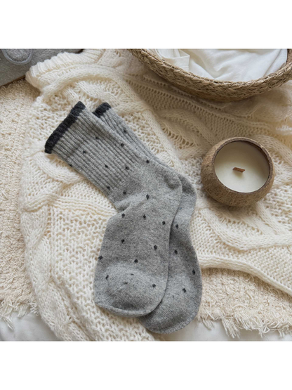 Light gray polka-dot crew socks with a dark gray ruffled cuff