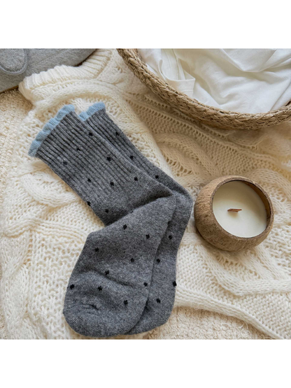 Gray polka-dot crew socks with a pale blue ruffled cuff