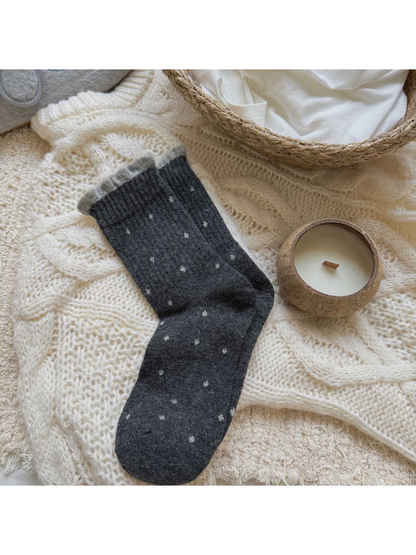 Dark gray polka-dot crew socks with a light gray ruffled cuff