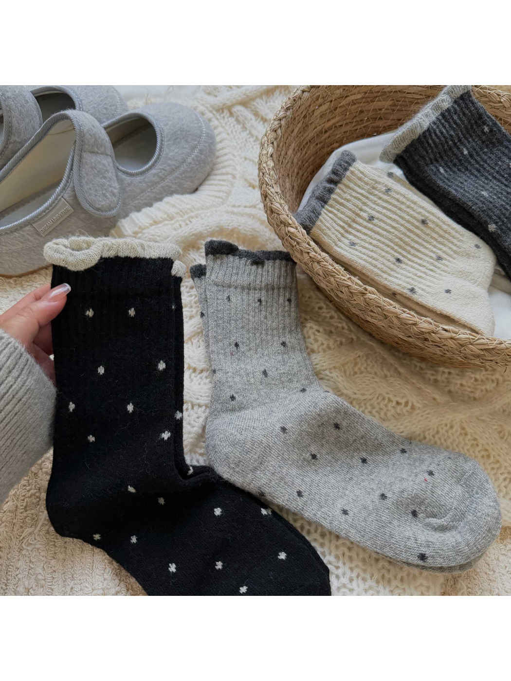 Black and light gray polka-dot crew socks displayed beside folded color options