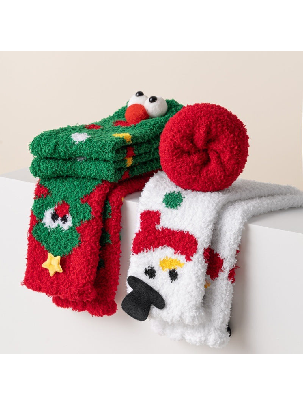 Fuzzy Christmas character socks folded and draped over a shelf