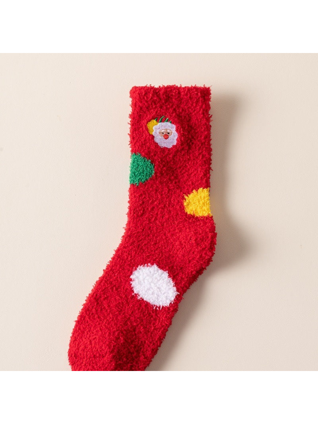 Red fuzzy sock with small Santa medallion and colorful patches
