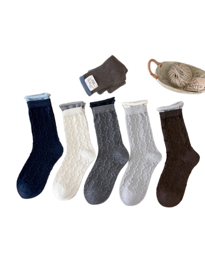 Navy, ivory, medium gray, light gray and brown textured crew socks displayed together