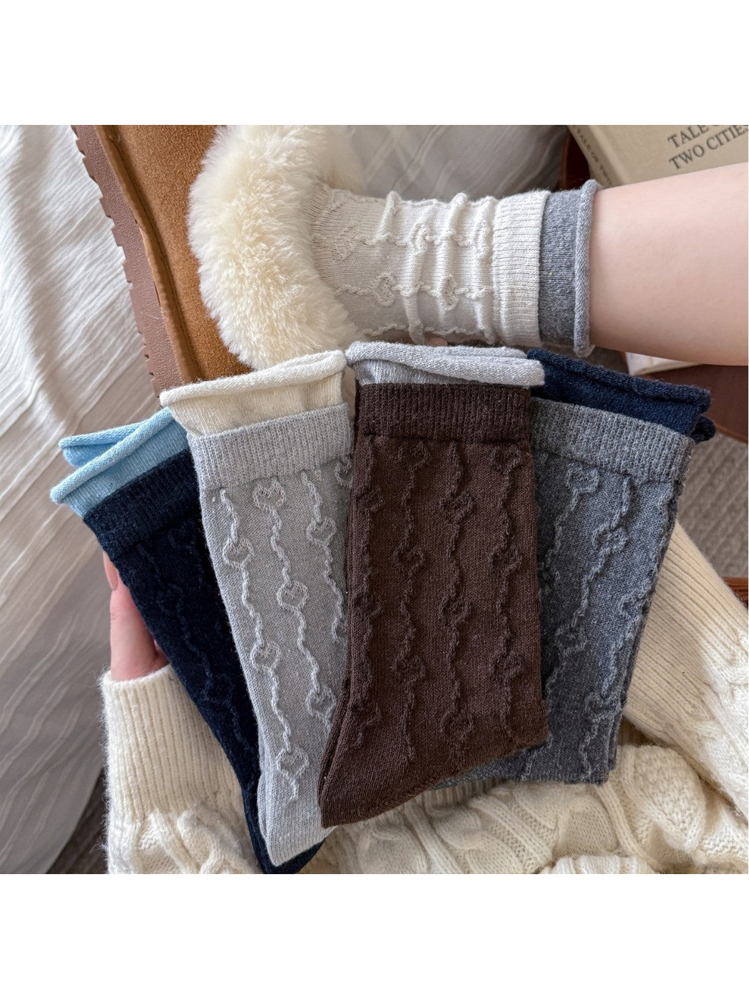 Five crew sock colors displayed with an ivory sock worn in a slipper