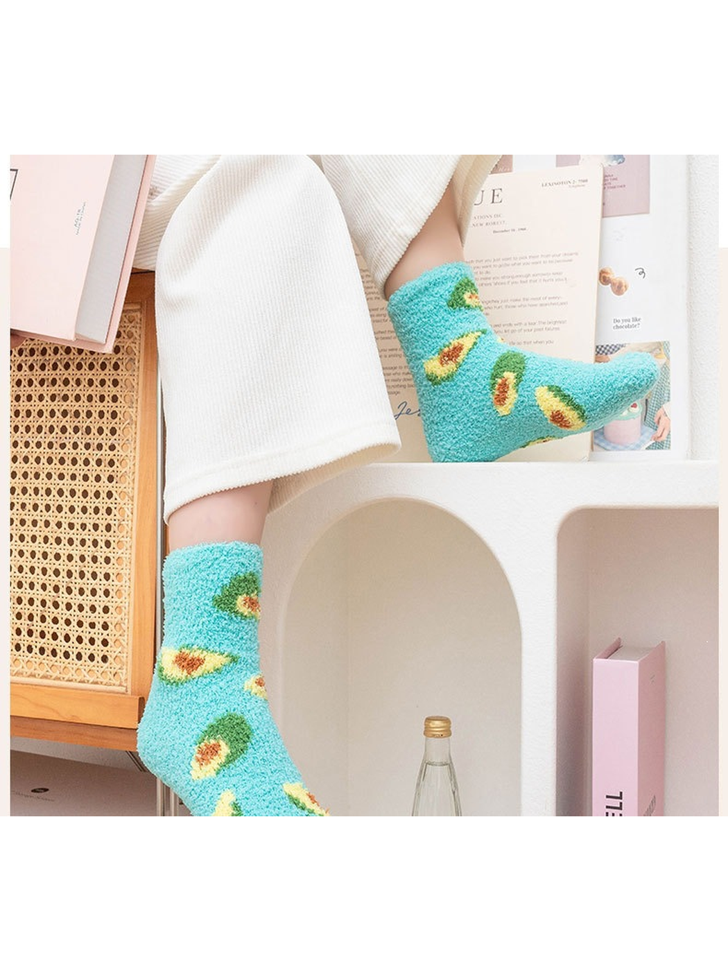 Turquoise fuzzy avocado crew socks worn in a bright indoor setting