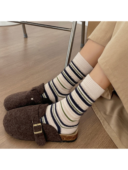 Ivory striped crew socks worn with brown clogs