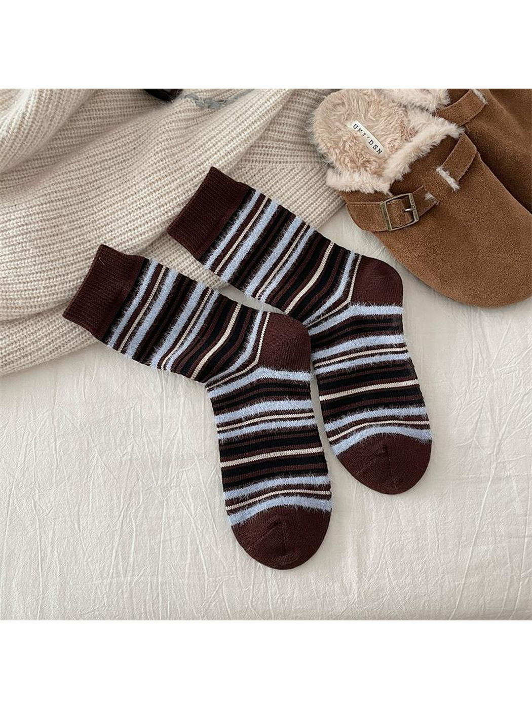 Dark brown crew socks with black, cream and pale blue stripes