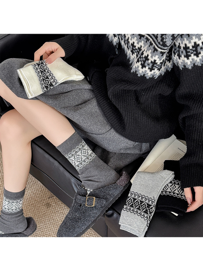 Dark gray geometric crew socks styled with gray clogs and folded color options