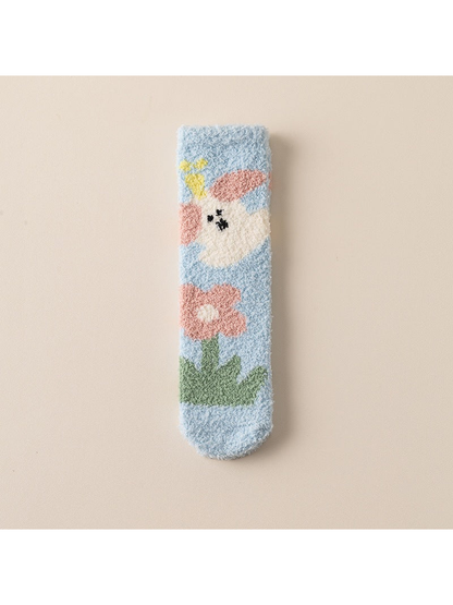 Light blue fuzzy crew sock with rabbit and flower motifs