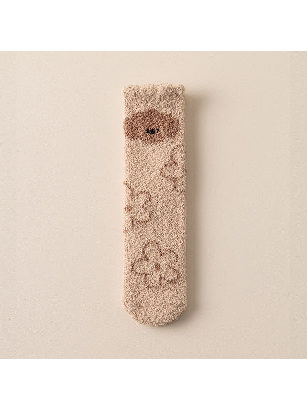 Beige fuzzy crew sock with brown bear and paw motifs