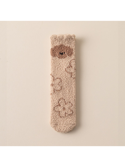 Beige fuzzy crew sock with brown bear and paw motifs