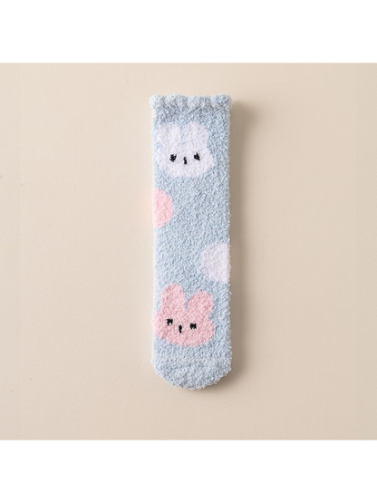 Light blue fuzzy crew sock with pink and white rabbit motifs