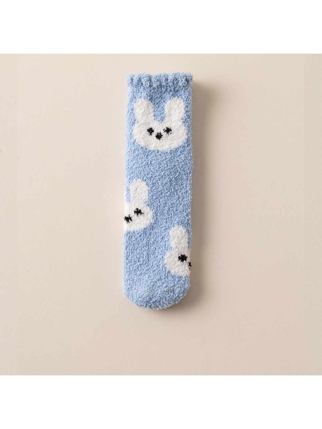 Light blue fuzzy crew sock with scattered white rabbit motifs