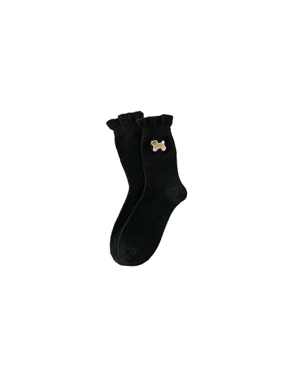 Black fuzzy crew socks with an embroidered dog motif