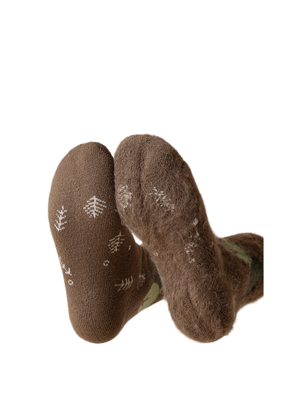 Close-up comparing the smooth outer sole and fuzzy inner surface of a brown sock