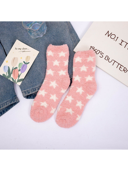 Pink fuzzy crew socks with repeating white stars