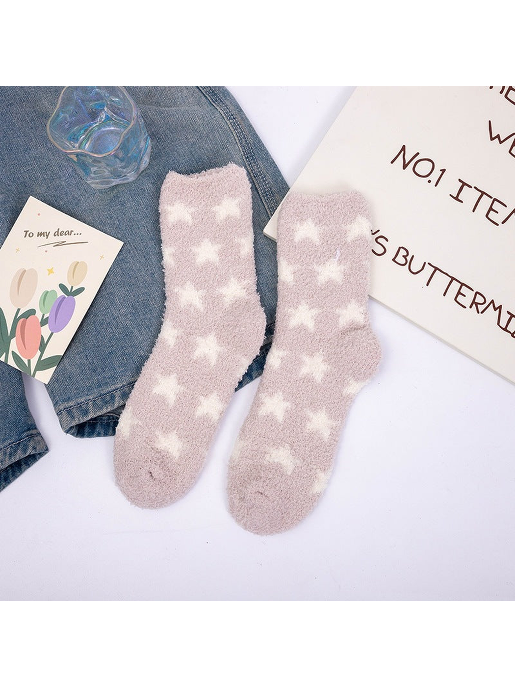 Beige fuzzy crew socks with repeating white stars
