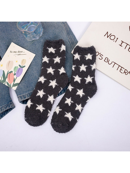 Black fuzzy crew socks with repeating white stars