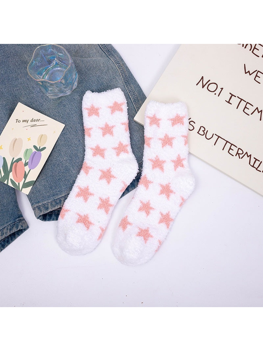 White fuzzy crew socks with repeating pink stars