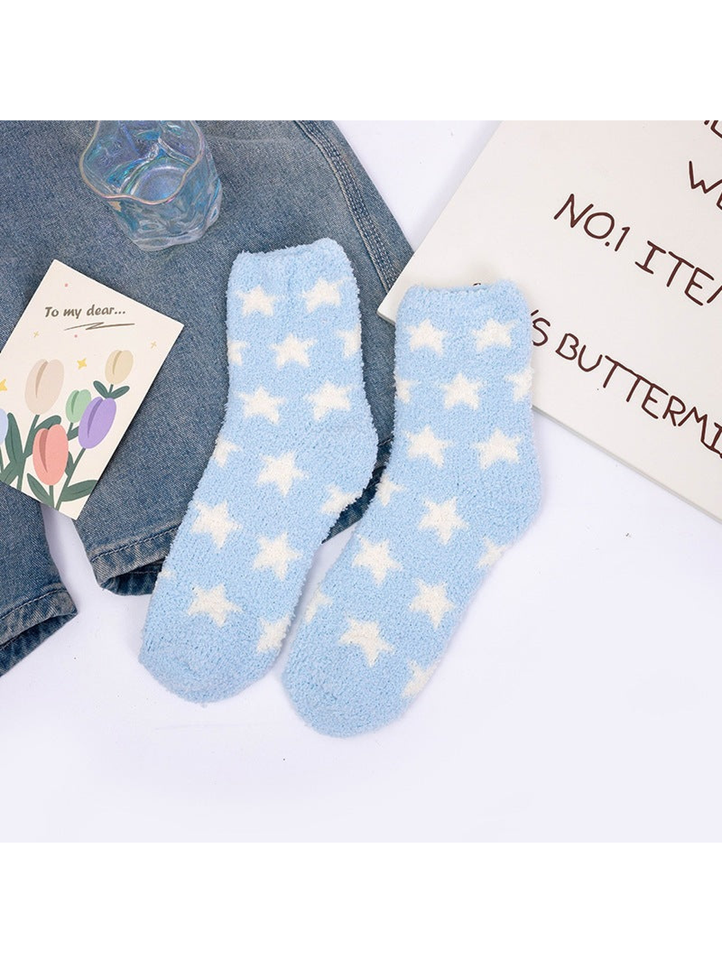 Light blue fuzzy crew socks with repeating white stars