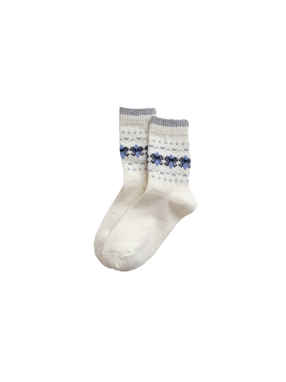 Cream crew socks with blue and black bow motifs and gray cuffs