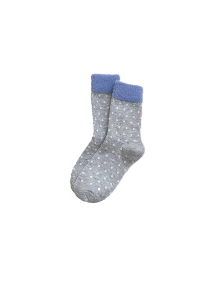 Gray crew socks with white polka dots and blue fuzzy cuffs